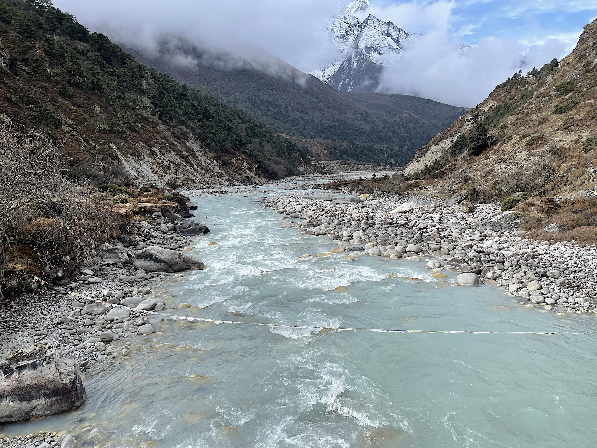 The bridge over the river is just above it, unlike the many high suspension bridges. The water is milky from minerals, giving the name Dudh Khosi, or milk river.