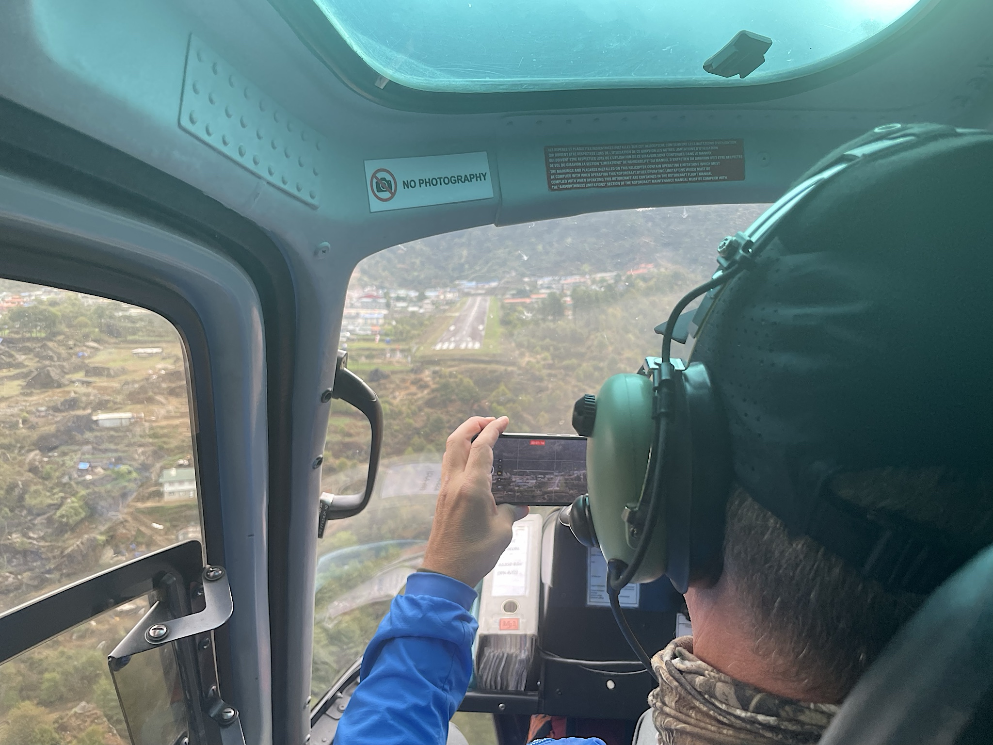 Chris carefully followed the no photography instruction. See the super-short runway, with a mountain at the far end. That’s Lukla. We were glad to be arriving by helicopter!